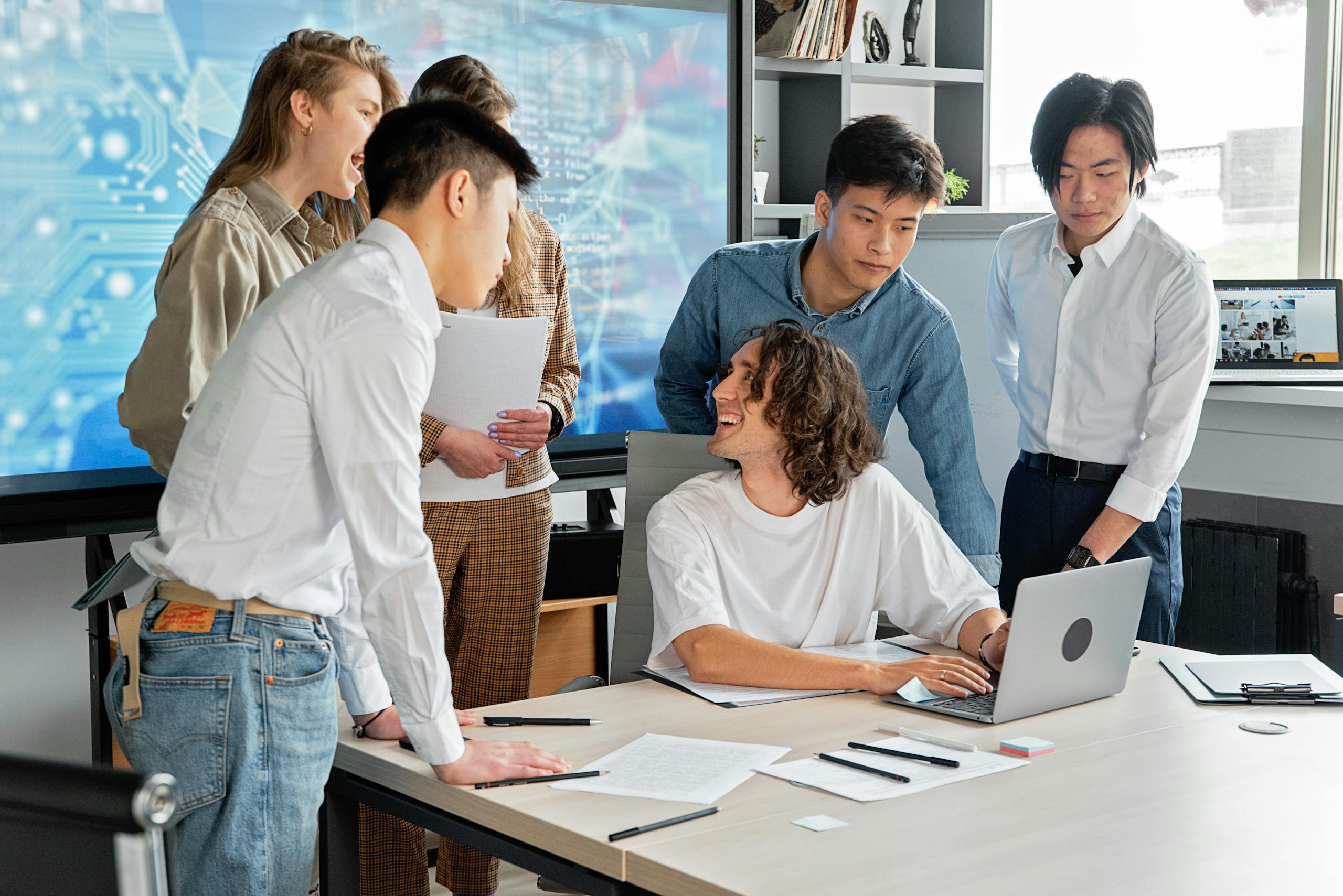 A diverse team of professionals engaged in a collaborative meeting in a modern conference room.